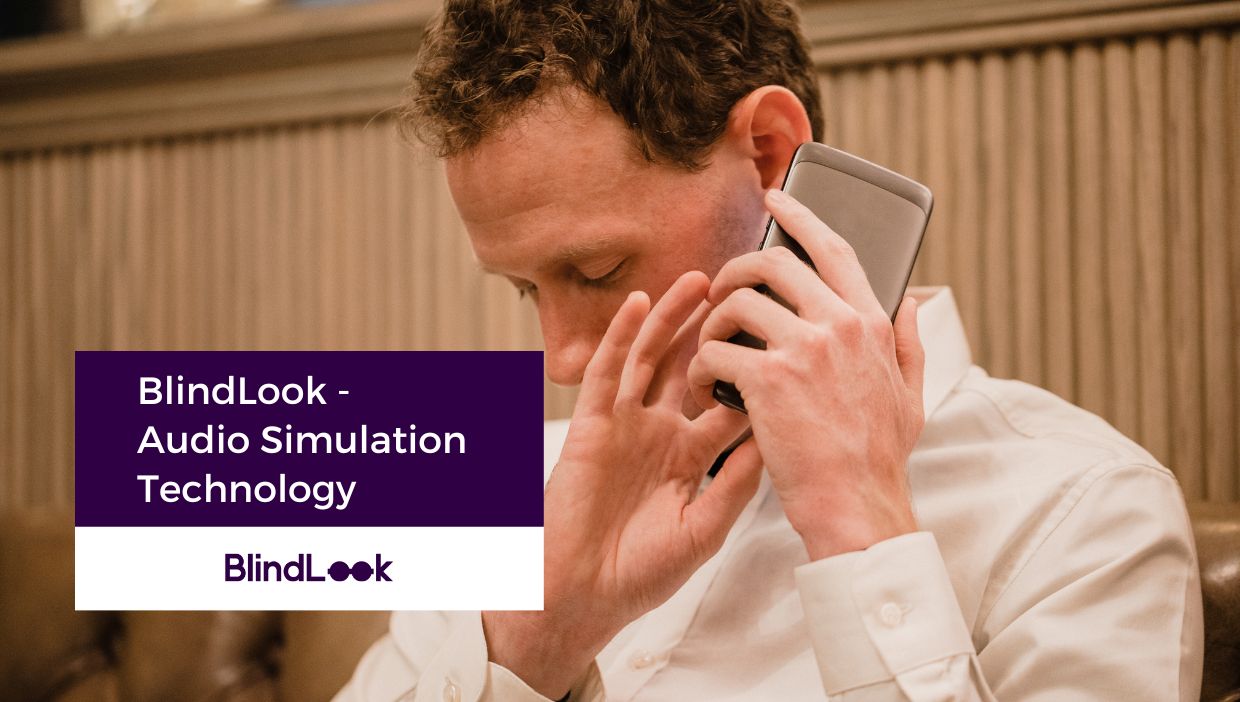 A visually impaired man listening at the phone with both hands