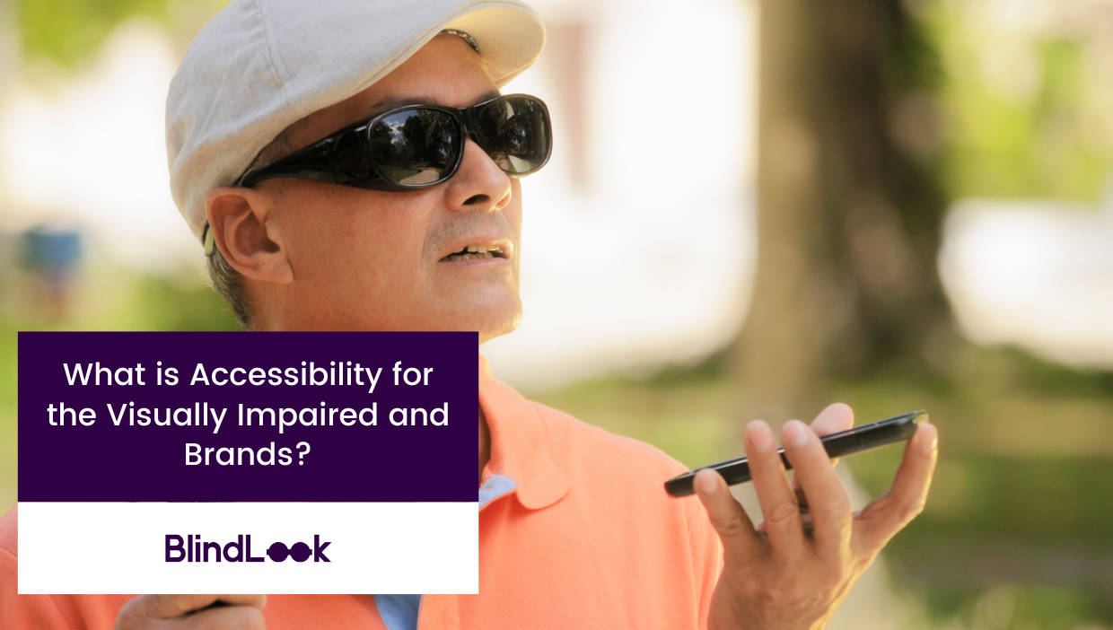 Image of a visually impaired man wearing sunglasses playing on his phone.