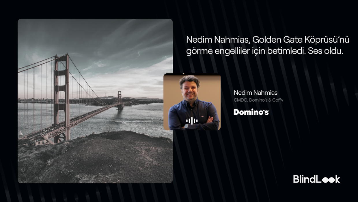 Golden Gate Köprüsü’nün bulutlu bir havada çekilmiş geniş açı fotoğrafı; köprü ve San Francisco Körfezi solda yer alıyor. Sağ tarafta koyu zemin üzerinde “Nedim Nahmias, Golden Gate Köprüsü’nü görme engelliler için betimledi. Ses oldu.” yazısı bulunuyor. Yazının yanında kolları çapraz, gülümseyen Nedim Nahmias’ın portresi, altında Domino’s logosu ve sağ altta BlindLook logosu yer alıyor.